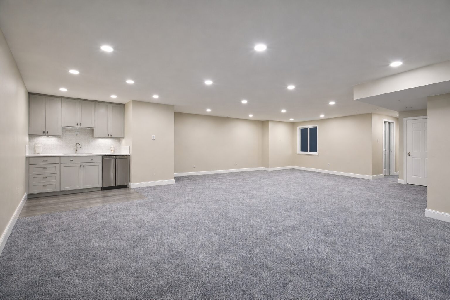 Finished basement with new carpet, recessed lighting, and a wet bar, by Griffin Renovation in Cache Valley, Utah